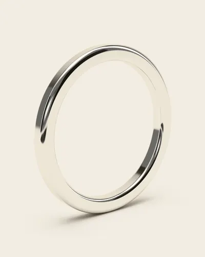 Grammi White Gold Band: a plain, slim, polished band, in 14k white gold, on an ivory background.