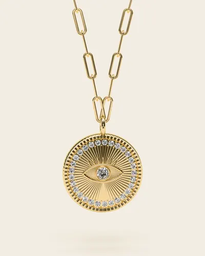 Mati Evil-Eye Necklace: a round medallion engraved with an eye and radiating lines, ringed with tiny clear stones, on a paperclip-link chain, in gold-plated 925 silver, on an ivory background.