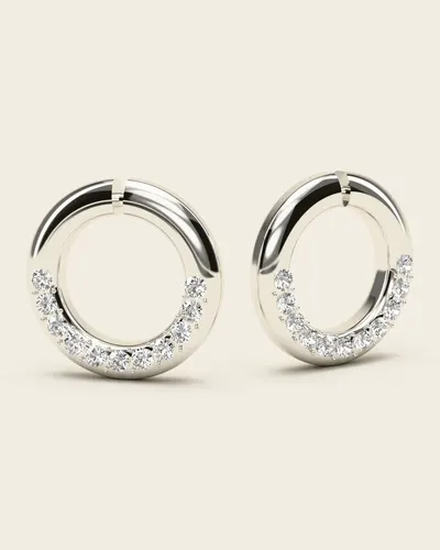 Pachni White Gold Huggies: a pair of small, thick huggie hoops with a curve of tiny clear stones set along the lower front, in 14k white gold, on an ivory background.