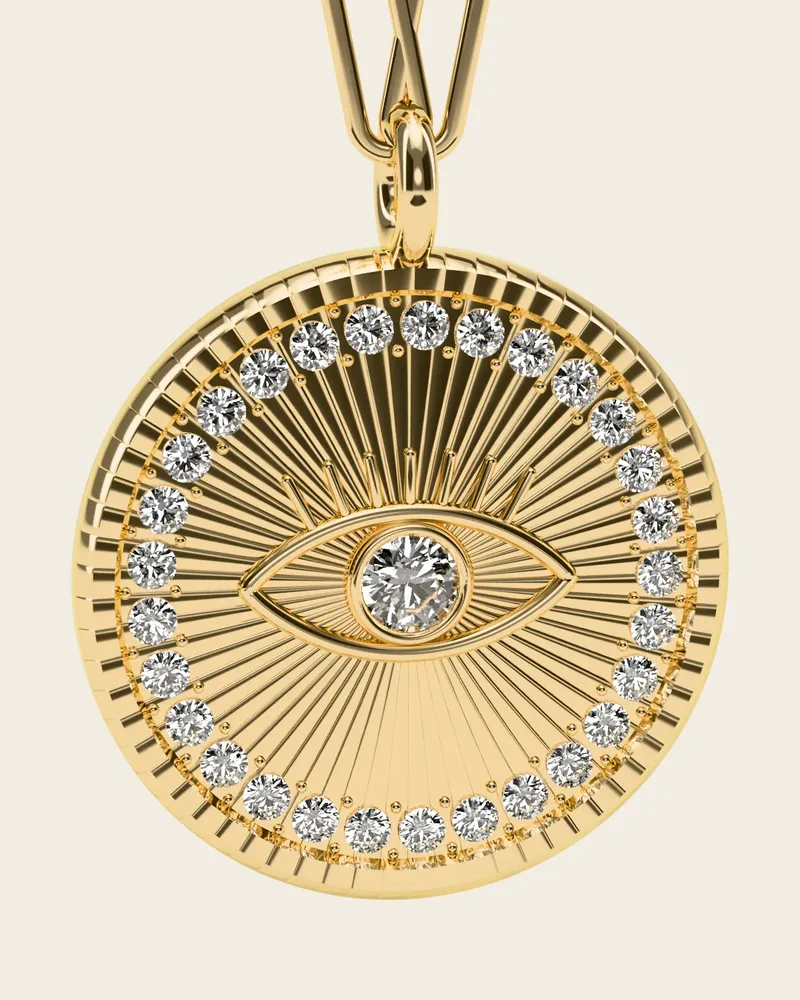 Mati Evil-Eye Necklace, gold-plated 925 silver. Close-up of the medallion: the engraved eye with a stone for the iris, the radiating lines and the ring of tiny stones.